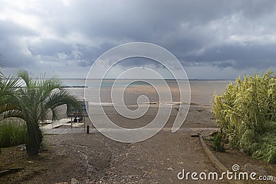 The beach of BenicÃ ssim-BenicÃ¡sim and the Mediterranean Sea joining with rainwater and floods producing a mixture of sediments l Stock Photo